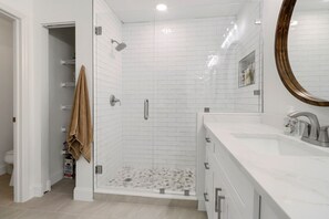 Shower, hair dryer, towels, toilet paper