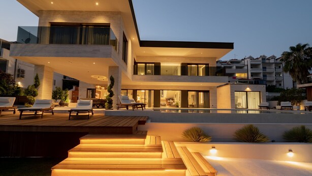 A modern multi-story house with a pool, outdoor seating, and a well-lit patio area. - Beachfront Villa Nautilux with Pool (Seget Donji)