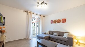 A modern living room with a grey sectional sofa, a wooden coffee table, and a floor lamp.