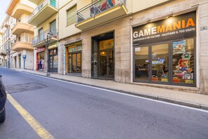 A street with storefronts, including a GameMania video game store.