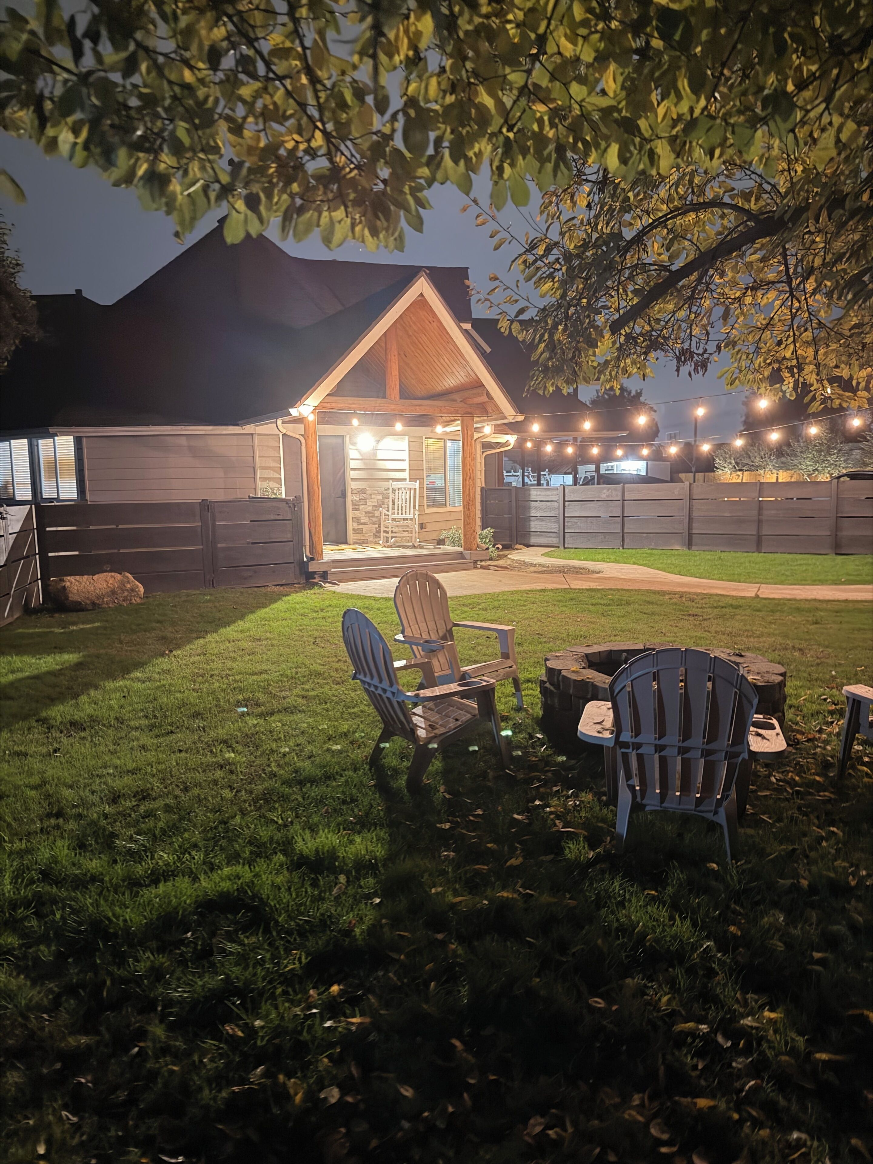 Private fenced front yard with firepit. 