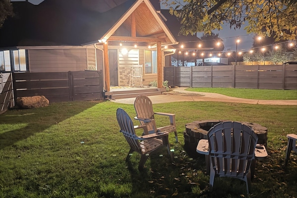 Private fenced front yard with firepit.