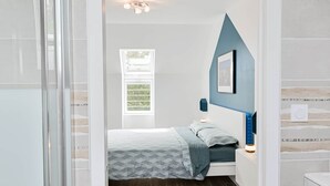 Una camera da letto moderna con un letto, un comodino e una finestra.