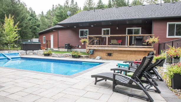 A house with a swimming pool, outdoor furniture, and a deck. - Pool and Hot Tub ,4 Bedroom  .3 Full Bath (Burk’s Falls)