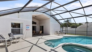 A modern pool area with a geometric glass roof, lounge chairs, and a clear view of the surrounding landscape. - Sunny Private Pool & Spa & Fenced Yard. Nr Parks (Kissimmee)