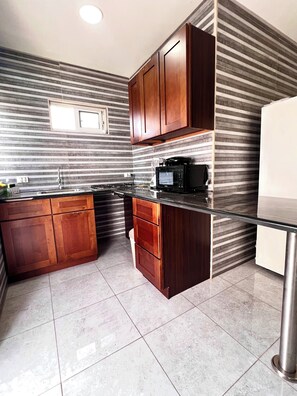 Fridge, microwave, stovetop, coffee/tea maker