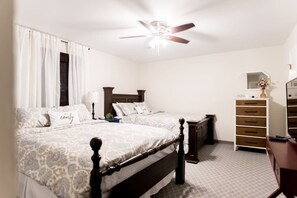 A bedroom with two beds, a ceiling fan, a dresser, and a mirror. - Country home, 11 mi to UTK (Powell)