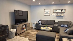 A living room with a fireplace, sofa, coffee table, and artwork on the wall. - Lake Seven, Frazee, MN (Frazee)