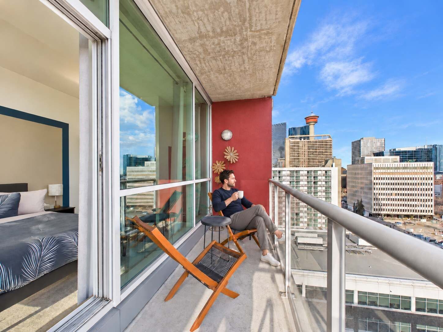 A balcony with a city view, a sofa, and a chair.