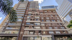 A multi-story building with balconies, large windows, and a modern architectural design.