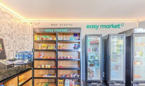 A grocery store interior with shelves stocked with various products, a refrigerated section, and a checkout counter. - Charming Apartment in Curitiba Nlv0506 (Curitiba)