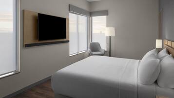 Una habitación de hotel moderna con una cama grande, un televisor de pantalla plana montado en la pared, una silla, una mesita de noche con lámparas y ventanas amplias.