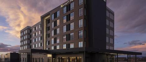 A multi-story hotel with a modern design, featuring a prominent 'Hyatt Place' sign at the top.