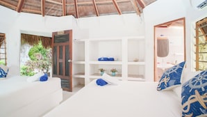 A room with a white bed, a wooden ceiling, and a view of the outside. - HOTEL ISLA MULATA (Rosario Islands)