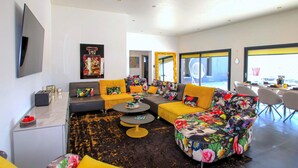 A modern living room with a sofa set, a coffee table, and a TV mounted on the wall. - Cozy home in Montboucher sur Jabron (Montboucher sur Jabron)