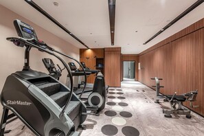 A fitness center with treadmills, an elliptical, and weight machines.