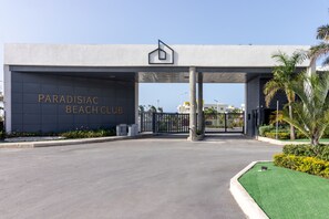 A modern building with a sign reading "Paradisiac Beach Club". - Paradisiac Euphoria Beach Access Pool 24hr Gated (Thompson Town)