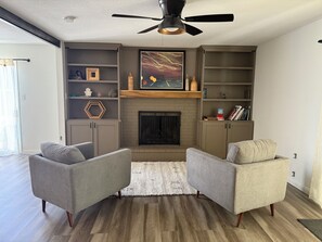 Smart TV, fireplace, books, printers