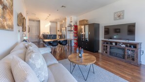 A modern living room with a sofa, coffee table, and entertainment unit.