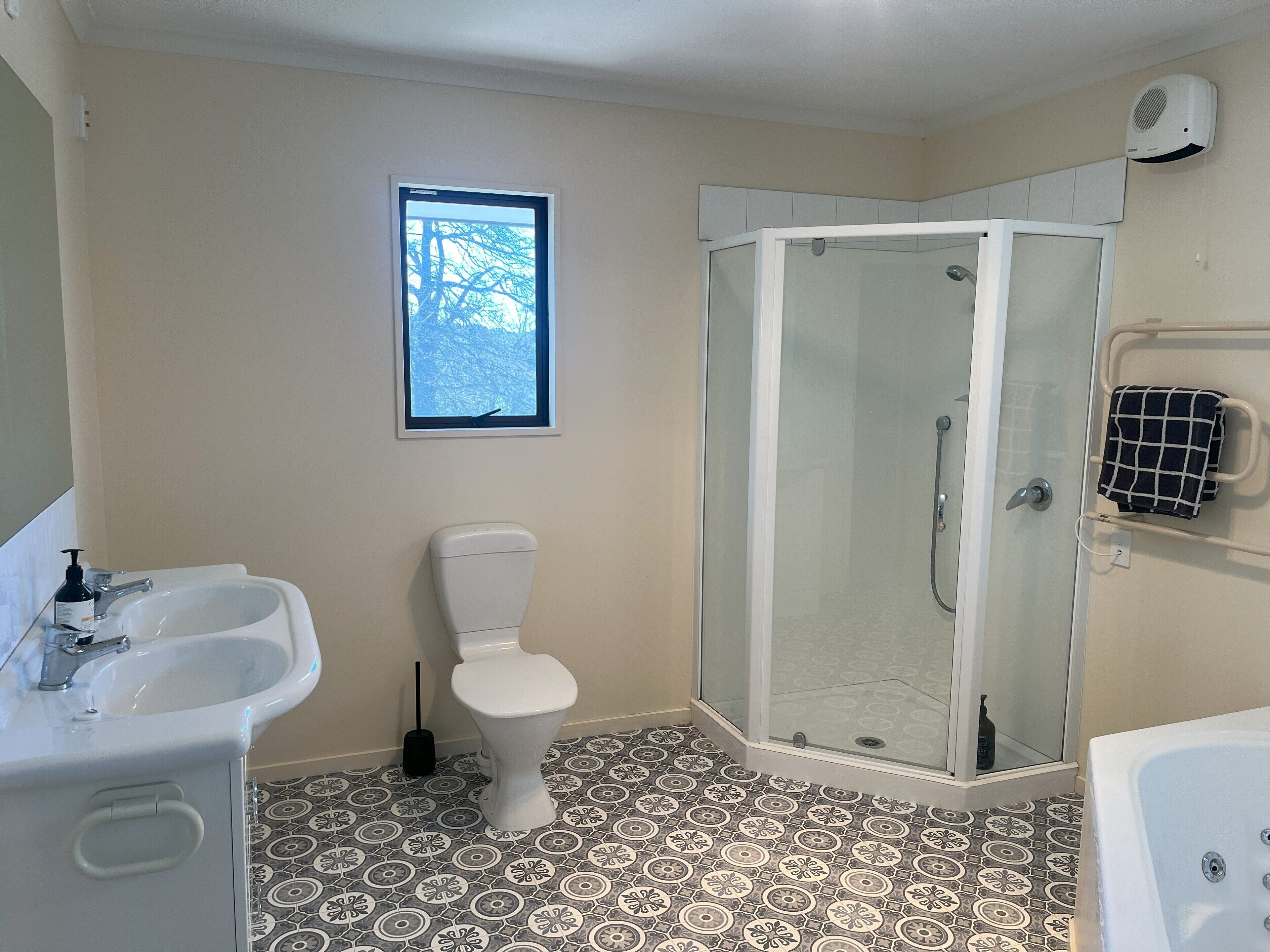 A bathroom with a toilet, sink, shower, and bathtub.