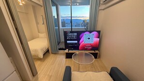 Standard Apartment, 2 Bedrooms, Balcony, City View | Living area | Flat-screen TV - CRYSTAL&RESORT EXCLUSIVE (Fukuoka)