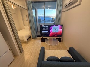 Standard Apartment, 2 Bedrooms, Balcony, City View | Living area | Flat-screen TV - CRYSTAL&RESORT EXCLUSIVE (Fukuoka)