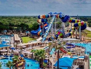 A water park with multiple water slides, pools, and a large central water feature. - Sheridan, Texas-Splash Away Getaway (Weimar)