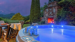 A swimming pool with a stone structure and a fire feature, surrounded by greenery. - Sleeps 22 On 17 Acres, River Access, Pet Friendly (Waynesville)