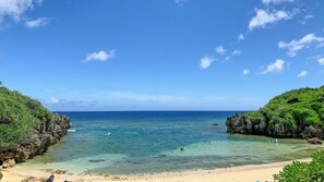 Beach nearby, white sand, beach umbrellas, beach towels