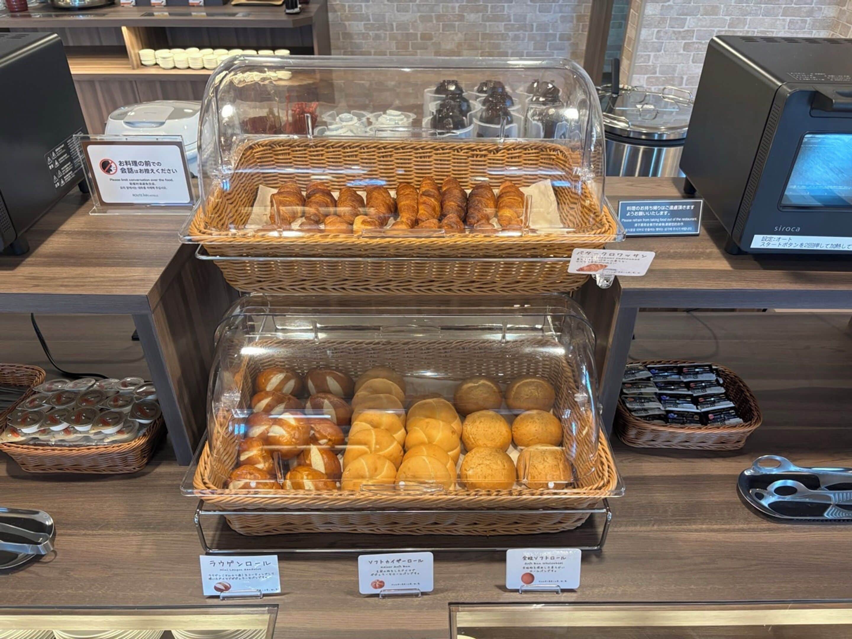 Mostrador de panadería con diversas delicias horneadas en cestas de mimbre, una máquina de café y una caja registradora.