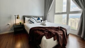 A modern hotel room with a large window, a neatly made bed, a bedside table with a lamp, and a view of the cityscape. - Staycation V Residence - Sunway Velocity (Kuala Lumpur)