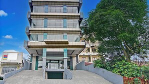 A multi-story building with a modern architectural design, featuring a central entrance and a flat roof. - Townhouse Oak Pekanbaru near Mall Pekanbaru formerly Hotel Grand Sahara (Pekanbaru)