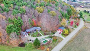 An aerial view of a rural property with two main buildings, a swimming pool, and a road. - Bearberry Suite @Cooperstown Lodge-3mi to CDP+Pool (Cooperstown)