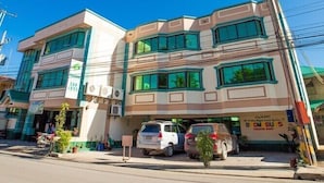 A multi-story building with a commercial ground floor, featuring a storefront with signage. - OYO 499 Le Pensione De San Jose (Tagbilaran)