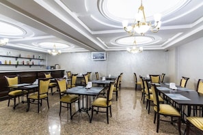 A conference room with a long table, chairs, and a bar area with shelves. - Royal Park Hotel (Almaty)