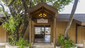 A wooden reception building with a sign reading 'TRANQUILITY' and a view of the interior.