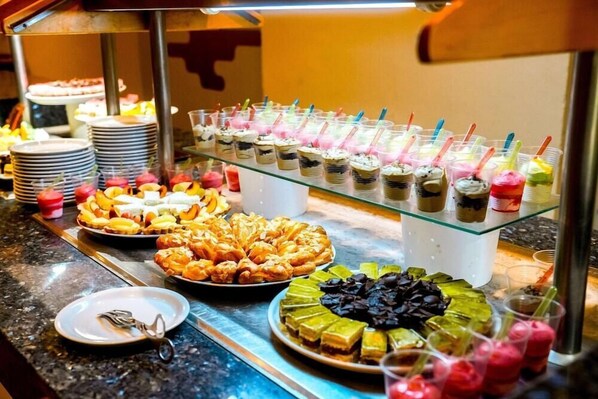 A buffet with various food items including pastries, desserts, and beverages. - Club Calimera Yati Beach (Djerba Midun)