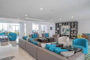 A modern living room with sofas, armchairs, and a bookshelf. - Sentido Marea (Varna)