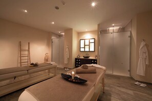 A spa room with a massage table, a small sink, and a mirror. - Sentido Marea (Varna)