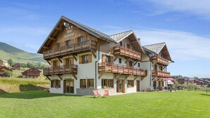 A large wooden building with multiple balconies and a sign reading "Hotel Restaurant". - Chalet-hotel Le Beausoleil, The Originals Relais (Fontcouverte-la-Toussuire)
