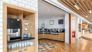 A modern kitchen with wooden cabinets, a coffee machine, and a variety of kitchenware. - Holiday Inn Express Birmingham - Walsall (Walsall)
