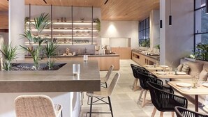 A modern interior with a central island, seating area, and a kitchen with shelves. - Contessina Suites & Spa - Adults Only (Zakynthos)