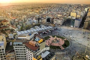 A cityscape with a central square surrounded by buildings. - Madame Roza (Istanbul)