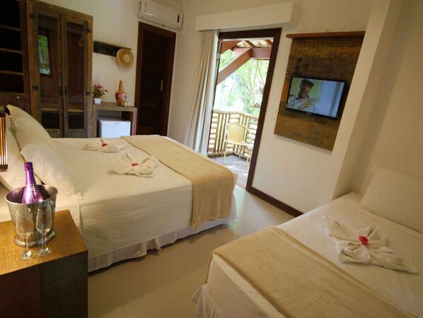 A hotel room with two beds, a TV, a minibar, and a balcony with a view.