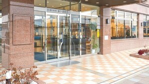 A hotel entrance with a checkered floor, glass doors, and a stone facade. - Toyoko Inn Sodegaura-eki Kita-guchi (Sodegaura)