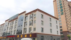 A multi-story hotel with a modern facade, featuring large windows and a prominent entrance.