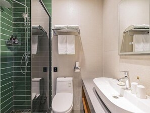 A modern bathroom with a glass shower enclosure, a toilet, and a sink with a mirror above it. - Green Tree Inn Express Beijing Wukesong Metro Station 301 PLA General Hospital (Beijing)