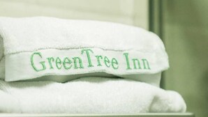 A white towel with "GreenTree Inn" embroidered in green. - Greentree Inn Hefei Railway Station Metro Station Zhanqian Road Square Express Hotel (Hefei)