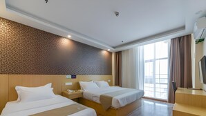 A hotel room with two beds, a desk, a TV, and a large window with curtains. - Greentree Alliance Yinchuan South Bus Station Hotel (Yinchuan)