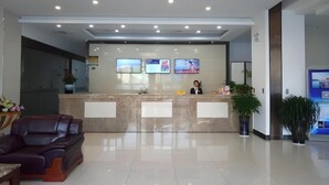 A modern hotel lobby with a reception desk, seating area, and potted plants. - Greentree Alliance Nantong Haimen Gangxin District Fujian Road Hotel (Nantong)